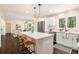 Open concept kitchen with a bright white island and stainless steel appliances at 9640 Cedar Grove Rd, Fairburn, GA 30213