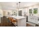 Bright kitchen featuring a large island, stainless steel appliances, hardwood floors and open concept to a sitting area at 9640 Cedar Grove Rd, Fairburn, GA 30213