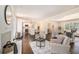 Open living room featuring a white brick fireplace, hardwood floors, and abundant natural light at 9640 Cedar Grove Rd, Fairburn, GA 30213
