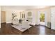 Cozy living room with a fireplace, large windows, and hardwood floors throughout at 9640 Cedar Grove Rd, Fairburn, GA 30213