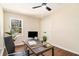Well-lit home office with modern desk, comfortable chair, and a window view at 9640 Cedar Grove Rd, Fairburn, GA 30213