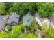 An aerial view showcases a home with green roof surrounded by mature trees at 966 Blue Ridge Ne Ave, Atlanta, GA 30306