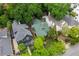 An aerial view showcases a home with green roof surrounded by mature trees at 966 Blue Ridge Ne Ave, Atlanta, GA 30306