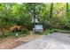 Landscaped backyard featuring a stone patio, fire pit and hot tub surrounded by lush greenery at 966 Blue Ridge Ne Ave, Atlanta, GA 30306