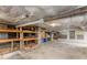 Basement featuring open shelving, brick foundation, concrete floor, and potential for storage or renovation at 966 Blue Ridge Ne Ave, Atlanta, GA 30306