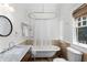 Bright bathroom with a freestanding tub, marble vanity, and a window with a view at 966 Blue Ridge Ne Ave, Atlanta, GA 30306