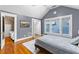 Cozy bedroom featuring a sloped ceiling, hardwood floors, and attached room and walk-in closet at 966 Blue Ridge Ne Ave, Atlanta, GA 30306