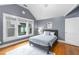 Bedroom with hardwood floors, neutral walls, a queen-size bed, and bright sunlight from the windows at 966 Blue Ridge Ne Ave, Atlanta, GA 30306