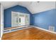 Bedroom features a blue wall, hardwood floors, and a window seat with natural light at 966 Blue Ridge Ne Ave, Atlanta, GA 30306
