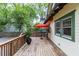 Outdoor deck space perfect for entertaining or relaxing with a red umbrella and views of the backyard at 966 Blue Ridge Ne Ave, Atlanta, GA 30306