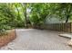 Long brick driveway with parking surrounded by trees and a wooden fence at 966 Blue Ridge Ne Ave, Atlanta, GA 30306