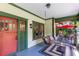 Inviting front porch with a porch swing, seating area, and red accents for a cozy, comfortable outdoor space at 966 Blue Ridge Ne Ave, Atlanta, GA 30306