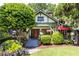 Charming home featuring a landscaped front yard with lush greenery, stone accents, and an inviting red door at 966 Blue Ridge Ne Ave, Atlanta, GA 30306