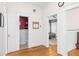 Hallway view into powder room and bedroom with hardwood flooring and white wainscoting at 966 Blue Ridge Ne Ave, Atlanta, GA 30306
