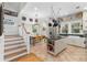 A well-lit kitchen featuring an island, a dining table, stainless steel appliances, and stairs at 966 Blue Ridge Ne Ave, Atlanta, GA 30306