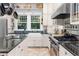 A large kitchen with a gas range, stainless steel appliances, and an island with a sink at 966 Blue Ridge Ne Ave, Atlanta, GA 30306