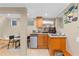 Small kitchen area with wood cabinets, granite counters, mini fridge and microwave in finished basement at 966 Blue Ridge Ne Ave, Atlanta, GA 30306