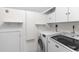 Laundry room with modern washer and dryer units and built-in storage cabinets at 966 Blue Ridge Ne Ave, Atlanta, GA 30306