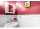 Powder room featuring pedestal sink, mirror, and artwork at 966 Blue Ridge Ne Ave, Atlanta, GA 30306