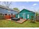 Backyard featuring a wood patio, green grass, a storage shed, and a privacy fence at 1027 Kirkwood Se Ave, Atlanta, GA 30316