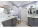 Stylish bathroom featuring double vanities with hexagon mirrors, a walk-in shower, and modern lighting at 1027 Kirkwood Se Ave, Atlanta, GA 30316