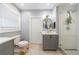 Stylish bathroom featuring double vanities with hexagon mirrors, a walk-in shower, and modern lighting at 1027 Kirkwood Se Ave, Atlanta, GA 30316