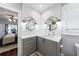 Bathroom featuring a sink, gray cabinets, two mirrors, white subway tile, and a window at 1027 Kirkwood Se Ave, Atlanta, GA 30316