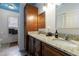 Bathroom featuring a double vanity with granite countertops, dark cabinets, and custom paint at 1027 Kirkwood Se Ave, Atlanta, GA 30316