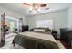 Cozy bedroom featuring a decorative fireplace, a ceiling fan, and a view of the office at 1027 Kirkwood Se Ave, Atlanta, GA 30316