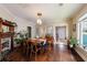 Cozy dining room featuring a fireplace, natural lighting, and hardwood floors at 1027 Kirkwood Se Ave, Atlanta, GA 30316
