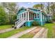 Charming teal home featuring a screened front porch with painted white stairs and foundation at 1027 Kirkwood Se Ave, Atlanta, GA 30316