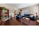 Inviting living room featuring hardwood floors, a fireplace, and a comfortable blue couch at 1027 Kirkwood Se Ave, Atlanta, GA 30316