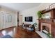 Bright living room featuring a brick fireplace, hardwood floors, and a view of the entryway at 1027 Kirkwood Se Ave, Atlanta, GA 30316