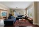 Open living room with natural light, a comfortable couch, hardwood floors and stylish decor at 1027 Kirkwood Se Ave, Atlanta, GA 30316