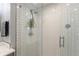 This bathroom features a shower with a glass enclosure, white tile, and stone flooring at 1027 Kirkwood Se Ave, Atlanta, GA 30316