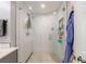 This bathroom features a shower with a glass enclosure, white tile, and stone flooring at 1027 Kirkwood Se Ave, Atlanta, GA 30316