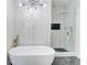 Bright bathroom featuring a soaking tub, stylish lighting, and a glass-enclosed shower with upscale fixtures at 1456 S Gordon Sw St, Atlanta, GA 30310