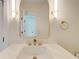 Bathroom showcases a marble countertop, arched mirror with sconces, and gold hardware at 1456 S Gordon Sw St, Atlanta, GA 30310