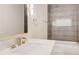 Bathroom featuring modern faucet with marble countertop and beautifully tiled shower and bath at 1456 S Gordon Sw St, Atlanta, GA 30310