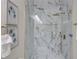 Luxurious marble shower with gold hardware and unique design elements at 1456 S Gordon Sw St, Atlanta, GA 30310