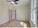 Bright bedroom featuring a ceiling fan, light hardwood floors, and a window for plenty of natural light at 1456 S Gordon Sw St, Atlanta, GA 30310
