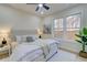 Bright bedroom with a cozy bed, ceiling fan, and a view of the fenced backyard at 1456 S Gordon Sw St, Atlanta, GA 30310