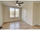 Bright bedroom featuring wood floors, a ceiling fan, and a double window allowing natural light to fill the space at 1456 S Gordon Sw St, Atlanta, GA 30310