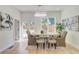 Bright dining room with a modern chandelier, stylish seating, and serene backyard views through French doors at 1456 S Gordon Sw St, Atlanta, GA 30310