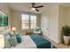 Comfortable bedroom featuring light walls, wood floors, ceiling fan and double window views at 1456 S Gordon Sw St, Atlanta, GA 30310