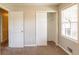 A bedroom with a window, sliding door closet, neutral walls and carpeted floors at 2877 Kensington Way, Rex, GA 30273