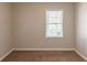 A bright bedroom with neutral walls, carpeted floors and a window letting in natural light at 2877 Kensington Way, Rex, GA 30273