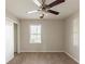 A bedroom that includes a ceiling fan, window, and closet with sliding doors at 2877 Kensington Way, Rex, GA 30273