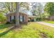 Charming brick home featuring a carport and a well-maintained front yard with mature trees at 2877 Kensington Way, Rex, GA 30273