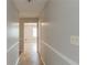 Hallway view showcasing neutral paint, trim, and flooring, leading to other rooms at 2877 Kensington Way, Rex, GA 30273